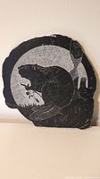 Front view of the soapstone carved plaque showing the beaver and nature scene.