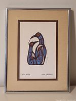 Framed Norval Morrisseau print titled "Bird Family" showing the entire artwork with frame and matting.
