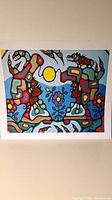 Frontal image of the colorful Norval Morrisseau print showing abstract animals and a central bright yellow sun shape with surrounding symbolic elements.