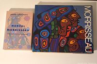 Photo of large and small Norval Morrisseau books side by side on a flat surface