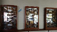 Three wooden wall display cases mounted side by side on a shelf, glass fronts filled with small figurines (content not included)