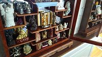 Tiered wooden display shelf with all figurines and decor pieces visible