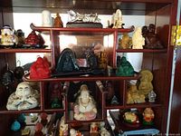 Display shelf with full assortment of figurines and pendants