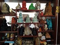 Front view of all figurines displayed on wooden shelf