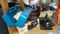 Overview of power sanders: blue Makita case, Black & Decker box, Dremel manual, and Dremel sander on work surface.