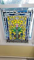 Full front view of the stained glass panel installed in window