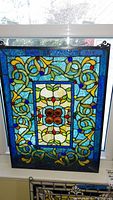 Full front view of the stained glass panel hung in window