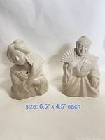 Front view of two white ceramic figurines, each holding a fan, measuring approximately 6.5 inches by 4.5 inches each.