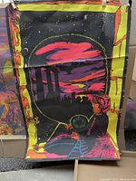 Full view of psychedelic poster showing a person with a hookah looking at a surreal sky with black silhouettes and neon pink and yellow hues