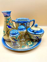 Photo of the complete ceramic Asian tea and spice set showing all items on the tray, including pitcher, salt and pepper shakers, covered bowl, and square holder.