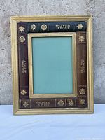 Front view of a rectangular mirror with frame designed as vintage book spines labeled Oliver Twist and A Tale of Two Cities.