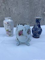 Photo showing three vintage decorative vases on concrete background highlighting shapes and designs
