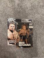 Sealed Brock Lesnar UFC Ultimate Collector action figure in original packaging, showing cardboard backing with image of Brock Lesnar and clear plastic blister containing the figure.