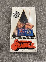 Photo showing sealed VHS tape packaging with iconic Clockwork Orange design and branding.