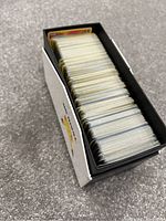 Top-down view of the opened Pokémon Elite Trainer Box filled with multiple Pokémon cards stacked inside demonstrating the quantity and condition of the cards.
