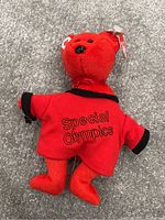 Photo of a red Beanie Baby bear with Special Olympics red shirt and Ty tag on ear