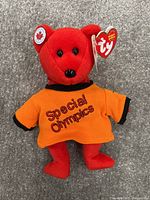 Red Ty Beanie Baby bear with Special Olympics shirt and Canadian flag ear detail.