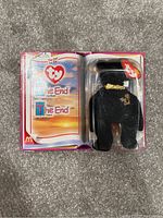 Image of Ty "The End" Beanie Baby in original unopened blister card packaging showing bear and card insert