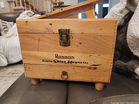 Front view of the wooden Ronson Roto-Shine Magnetic shoe shine kit box showing the brand and series name on the box.