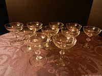 Set of 10 clear glass apéritif glasses shown arranged together, showcasing overall quantity and condition.