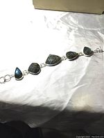 Full length view of labradorite silver bracelet showing all stones and clasp