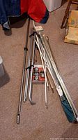 Overview photo showing metal rods of varying lengths and colors laid on carpet.