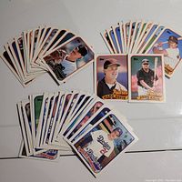 Photo showing spread of multiple 1988 Topps baseball cards primarily of National League West teams: Dodgers, Giants, Padres. Includes featured cards of Mark Davis and John Kruk. Cards laid out on a white table surface with good lighting to show condition.