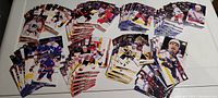 Photo showing multiple stacks of 2022-2023 Upper Deck NHL Series 1 cards spread out on a flat surface. Cards show players from the Metropolitan Division teams in full color.