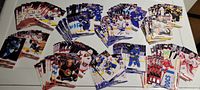 Multiple stacks of 2022-2023 NHL Upper Deck Series 1 hockey cards showing players from eight Atlantic Division teams arranged in groups by team.