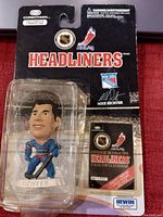Front view of Mike Richter bobblehead in original sealed packaging, showing figure and included collector's catalog.