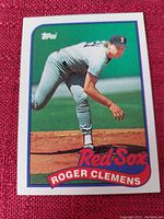 Front view of a Topps baseball card featuring Roger Clemens pitching for the Boston Red Sox.