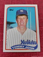 Front side of the Tommy John baseball card showing player image and team logo.