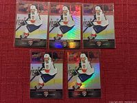 Five Aleksander Barkov hockey cards from Upper Deck, showing player in Florida Panthers hockey uniform. Three cards have a non-holographic finish, two cards have a holographic rainbow foil finish.