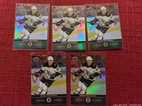 Photo of five David Pasternak Boston Bruins hockey cards, three holographic and two standard, all in excellent condition.