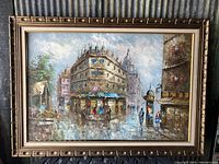 Full frontal image of framed oil painting depicting an old city street scene with a bar and group of pedestrians.
