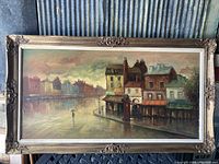 Front view of the large original painting showing urban waterfront scene and ornate frame with decorative corners and edges.