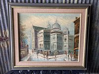 Full view of framed painting showing a multi-domed building with people in foreground, painted on canvas and mounted in gold wooden frame with pink fabric matting.