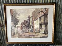 Framed vintage watercolour painting showing old street with buildings and trees