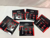 Five Dior Rouge Ultra Rouge lipstick travel samples with 4 color lip shapes each and one lip brush in blister packaging.