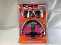 Front view of new sealed Champion Eyes & Ears combo package containing clear ballistic shooting glasses and pink noise reduction ear muffs.