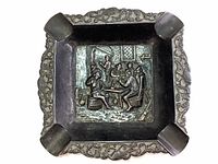 Full top view of the square ashtray showing the embossed tavern scene and decorative border.