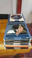 Stack of multiple vintage CED video discs with Star Wars on top showing original cover artwork on sleeves.