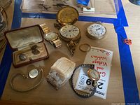 Overview of all watches, cufflinks and ring on tabletop