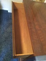 Open drawer showing the interior wood and dovetail construction of the drawers.