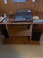 Photo of the Realistic Clarinette 48 music system on wooden stand, including separate speaker to side