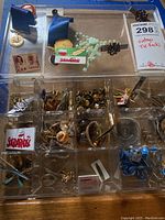 Top view showing tie bars, rosary, cameo tie tacks, enamel cross tie tack, money clip