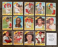 Front-facing photo of 15 individual 1966 Topps St. Louis Cardinals baseball cards, featuring players such as Bob Gibson, Tim McCarver, Curt Flood, and Red Schoendienst, arranged in a grid.
