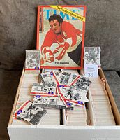 Wide view showing the box filled with thousands of unsorted cards along with loose cards and the Time magazine propped at the back