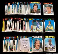 Full view of the bulk 1986 Topps Traded baseball card near set containing 131 of 132 cards laid out in rows by team groups, shows card fronts and player photos clearly to show condition and completeness of the lot.