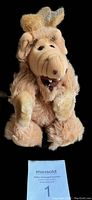 Front view of the 1987 ALF plush finger puppet toy showing its facial details and fur texture on black background.